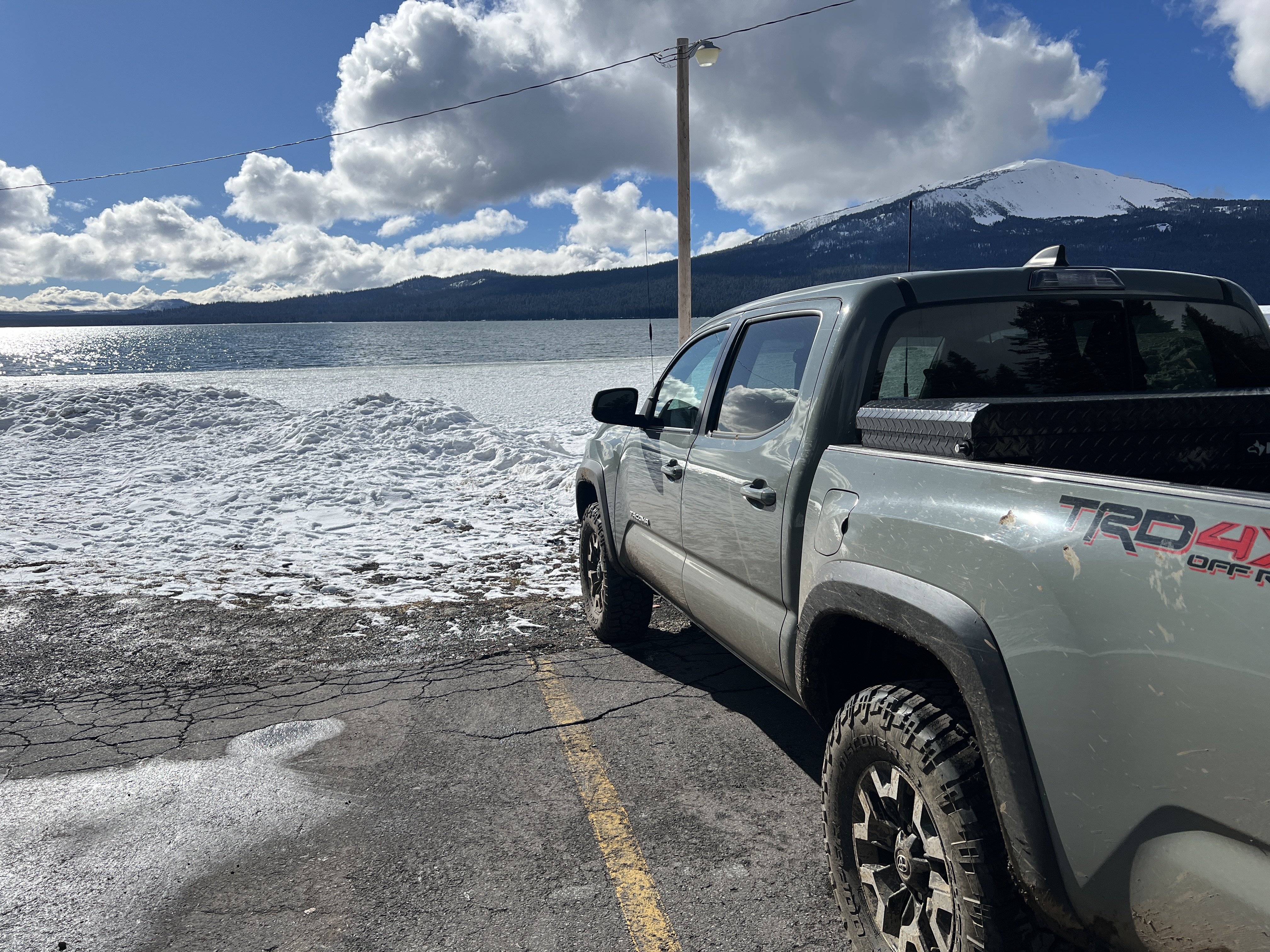 Truck infront of a snowy lake